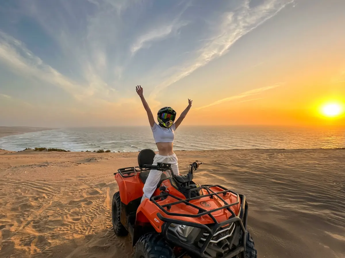 Rider on orange quad bike overlooking Agadir coast at sunset
